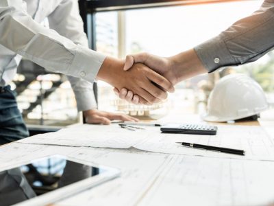 Architect And Engineer Construction Workers Shaking Hands While